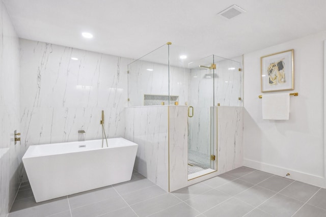 bathroom featuring tile patterned flooring and shower with separate bathtub