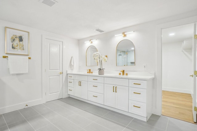 bathroom with tile patterned floors and vanity