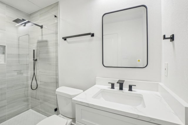 bathroom with toilet, an enclosed shower, and vanity