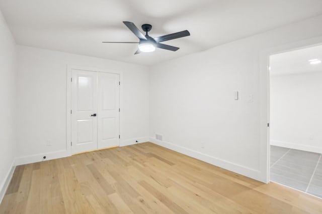 interior space with ceiling fan, a closet, and hardwood / wood-style flooring