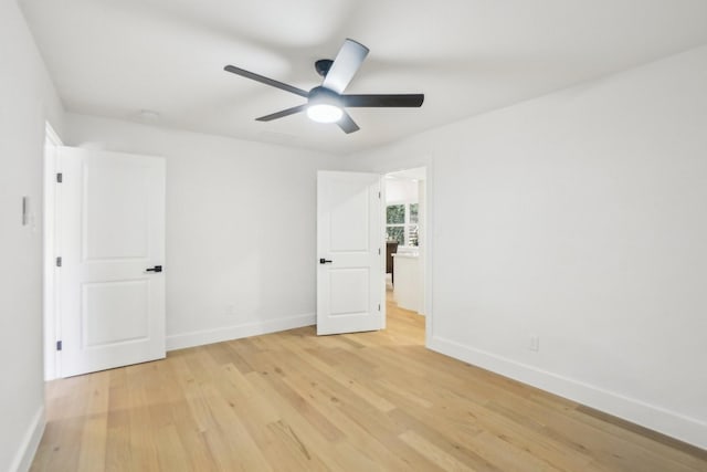 empty room featuring ceiling fan and light hardwood / wood-style floors