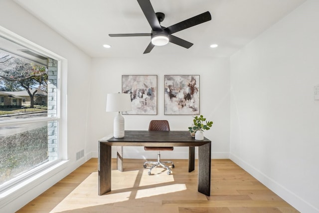 office space with ceiling fan and light hardwood / wood-style floors