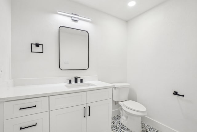 bathroom featuring toilet, tile patterned flooring, and vanity