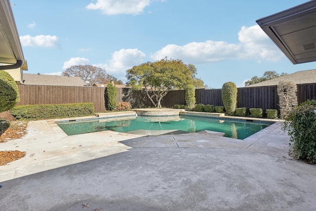 view of swimming pool featuring a patio area and a hot tub