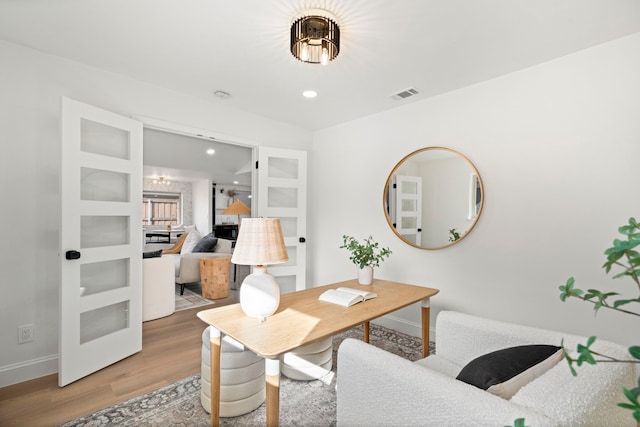 home office featuring built in features and hardwood / wood-style floors