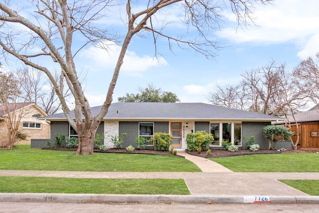 ranch-style home with a front lawn