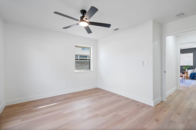 spare room featuring ceiling fan and light hardwood / wood-style flooring