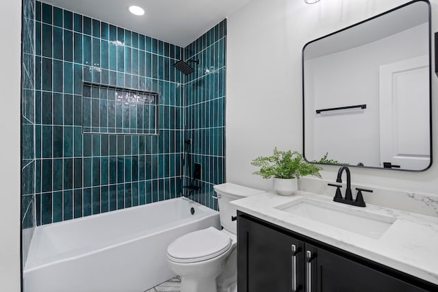 full bathroom with toilet, vanity, and tiled shower / bath