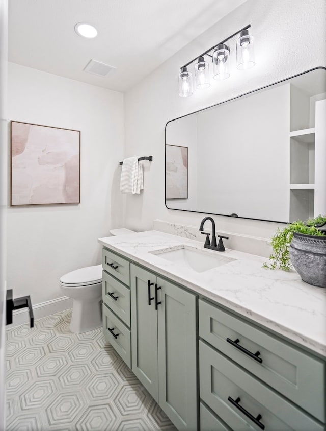 bathroom with toilet and vanity