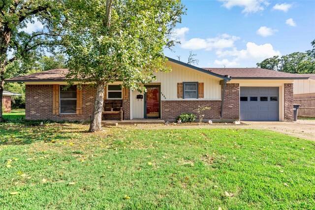 single story home featuring a garage and a front lawn