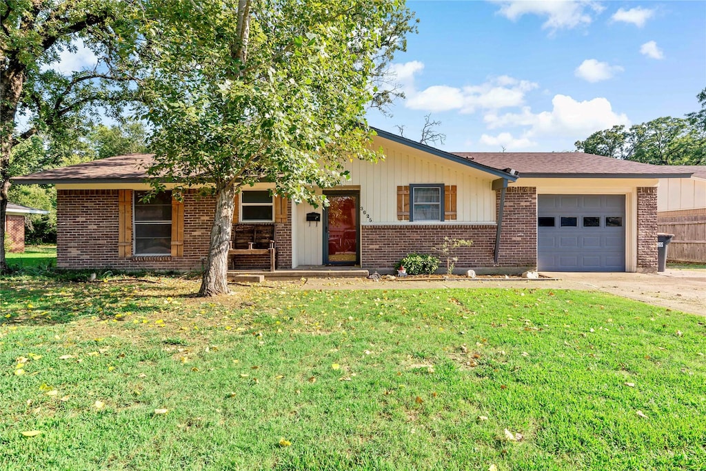 ranch-style home with a garage and a front yard