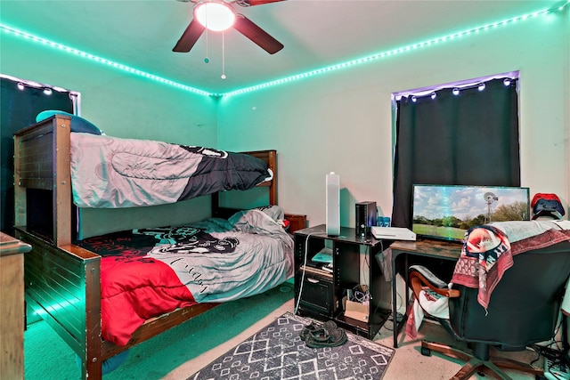 bedroom featuring ceiling fan and carpet