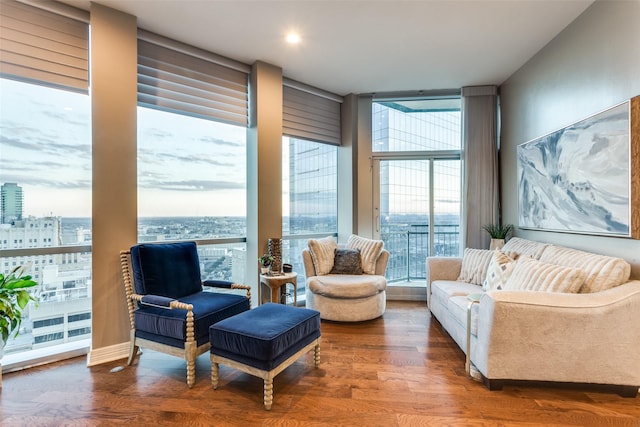 living room featuring hardwood / wood-style flooring and a wall of windows