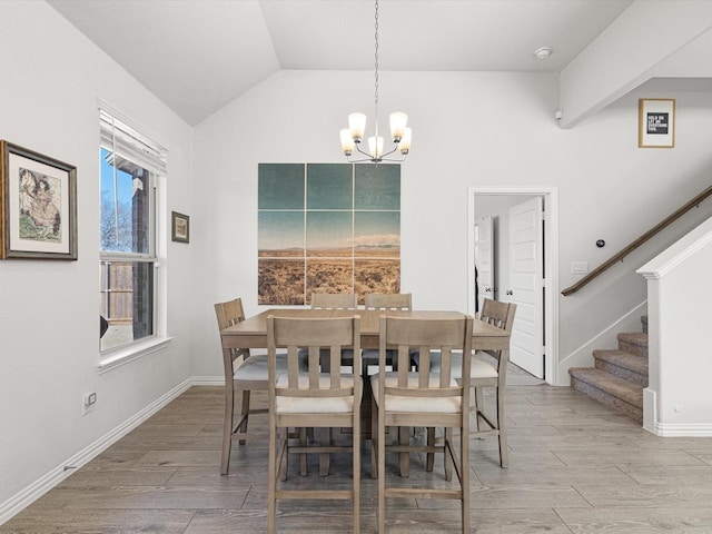 dining space with vaulted ceiling and a notable chandelier