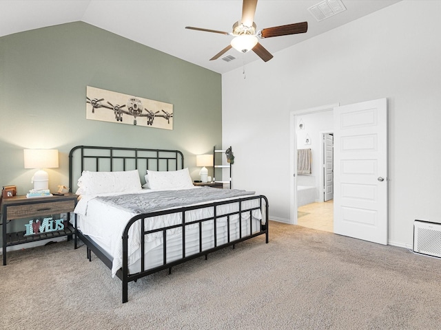 carpeted bedroom with ceiling fan, ensuite bath, and vaulted ceiling