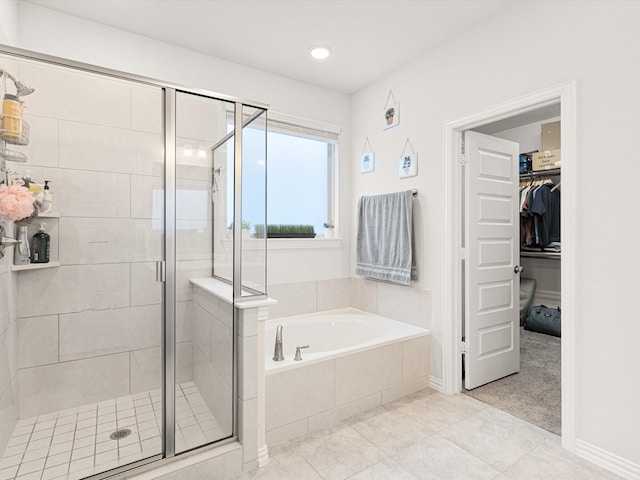 bathroom featuring separate shower and tub