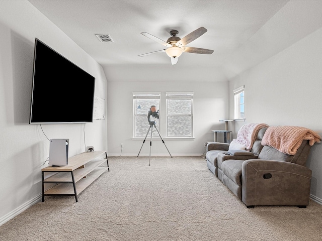 living room with ceiling fan, light colored carpet, and vaulted ceiling