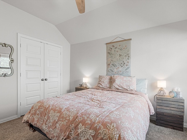 carpeted bedroom featuring ceiling fan, a closet, and vaulted ceiling