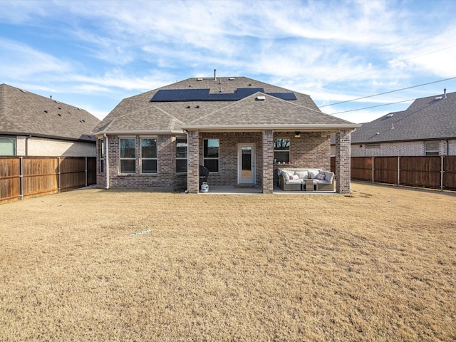 back of property with outdoor lounge area, a yard, and a patio