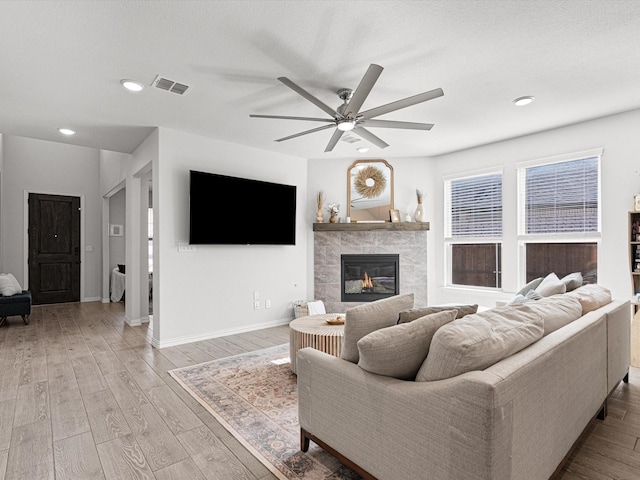 living room with ceiling fan and light hardwood / wood-style flooring