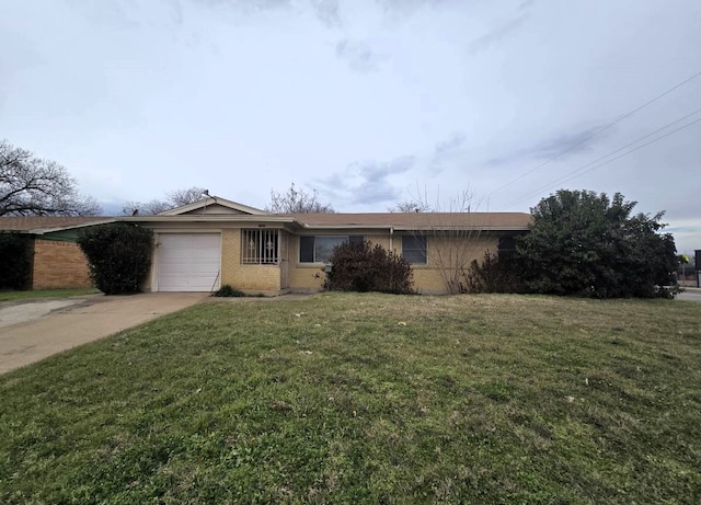 single story home featuring a garage and a front lawn