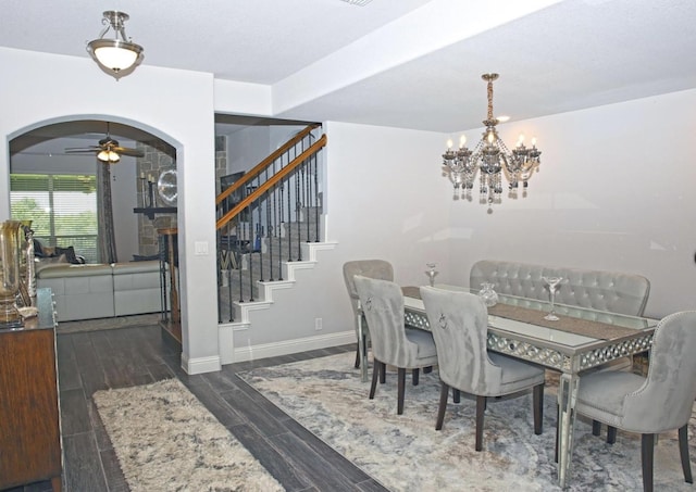 dining room featuring ceiling fan with notable chandelier