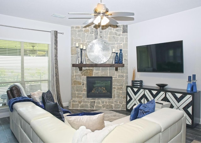 living room featuring ceiling fan, a fireplace, and hardwood / wood-style flooring