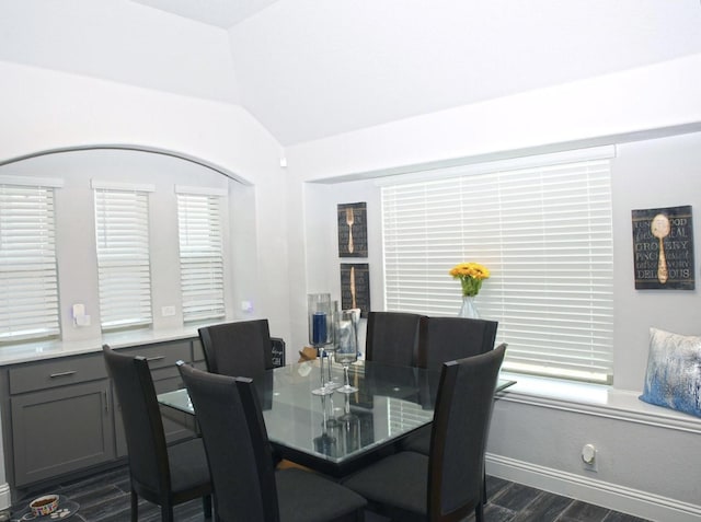 dining area featuring dark hardwood / wood-style flooring and lofted ceiling