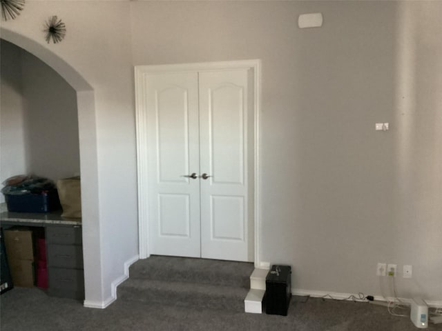 hallway with dark carpet