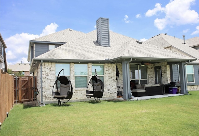 rear view of house featuring a lawn and an outdoor hangout area