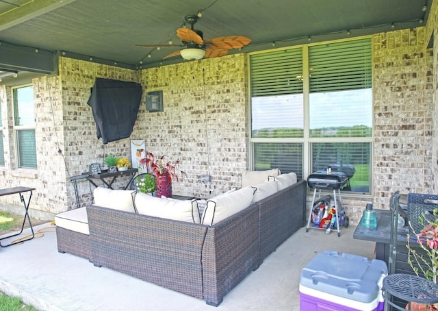 view of patio / terrace with ceiling fan, an outdoor living space, and a grill