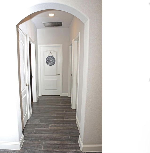 hallway with dark wood-type flooring