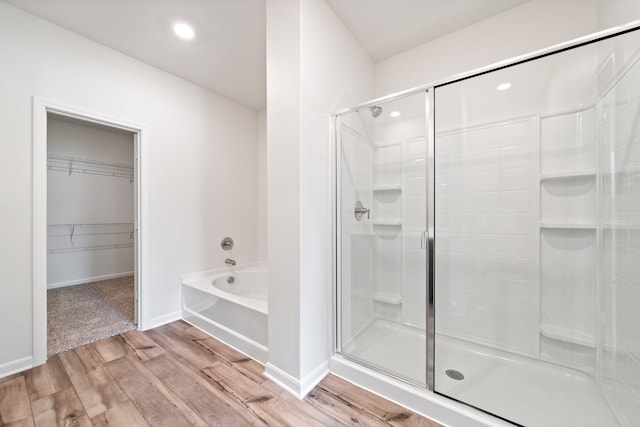 bathroom featuring separate shower and tub and hardwood / wood-style floors