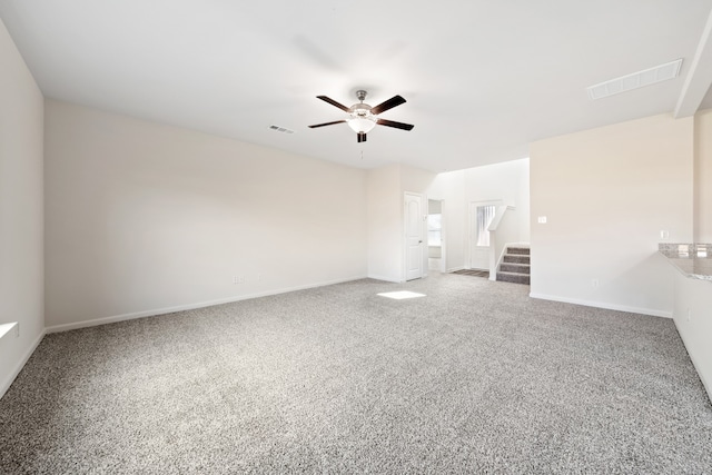 spare room featuring ceiling fan and carpet