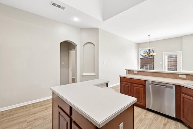 kitchen with dishwasher, a center island, decorative light fixtures, light hardwood / wood-style floors, and a notable chandelier