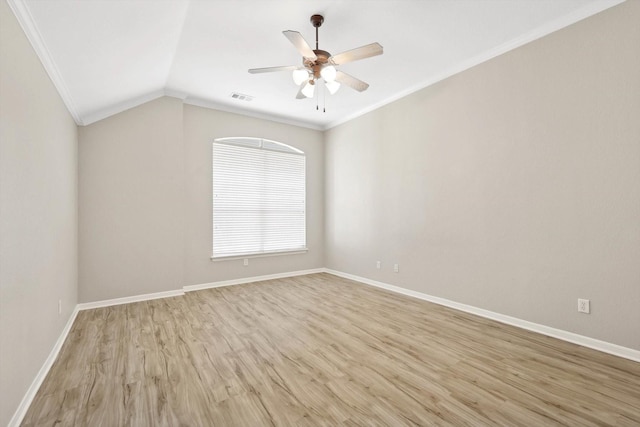 spare room with ceiling fan, ornamental molding, lofted ceiling, and light hardwood / wood-style floors