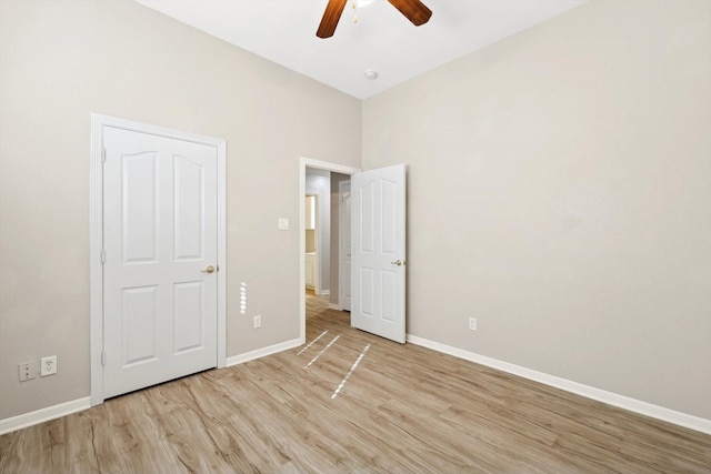 unfurnished bedroom with ceiling fan and light wood-type flooring