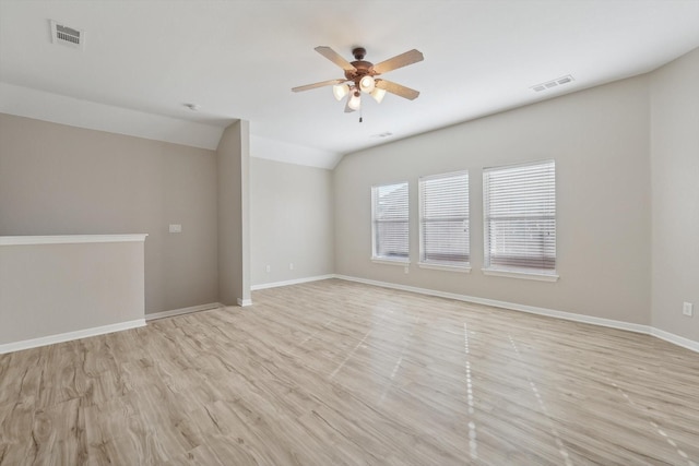 unfurnished room featuring light wood-type flooring, vaulted ceiling, and ceiling fan