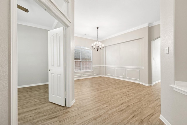 unfurnished dining area with a notable chandelier, crown molding, and light hardwood / wood-style flooring