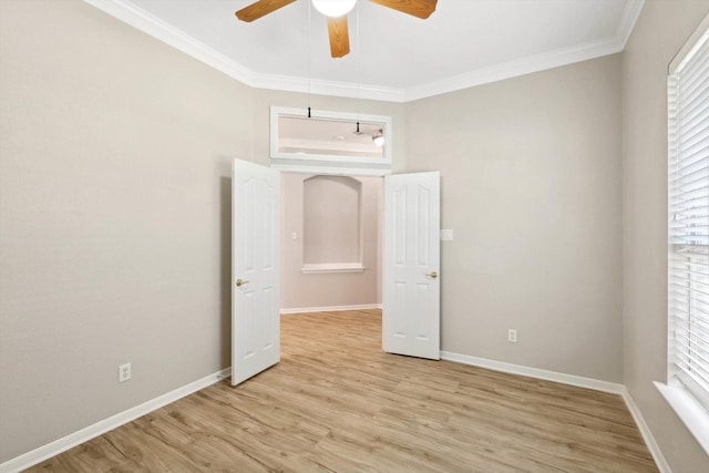 unfurnished bedroom with ceiling fan, crown molding, and light wood-type flooring