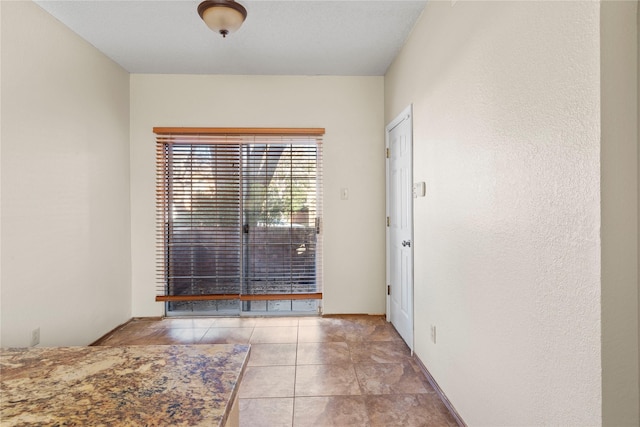 foyer entrance featuring light tile patterned flooring