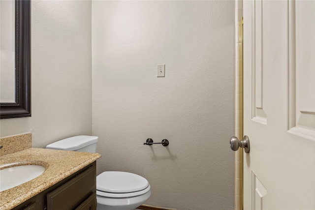 bathroom featuring toilet and vanity