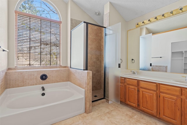 bathroom featuring lofted ceiling, vanity, tile patterned flooring, independent shower and bath, and a textured ceiling