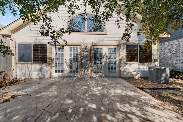 rear view of house featuring cooling unit, french doors, and a patio