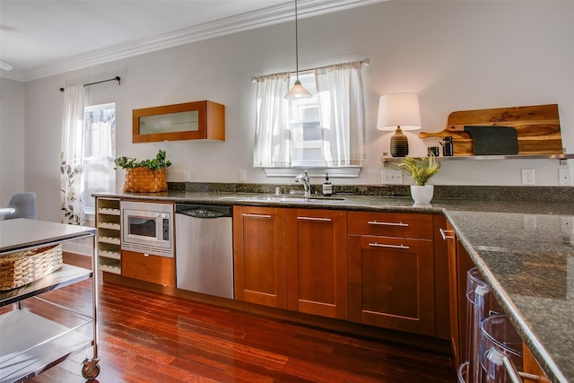 kitchen with appliances with stainless steel finishes, decorative light fixtures, sink, dark hardwood / wood-style floors, and ornamental molding