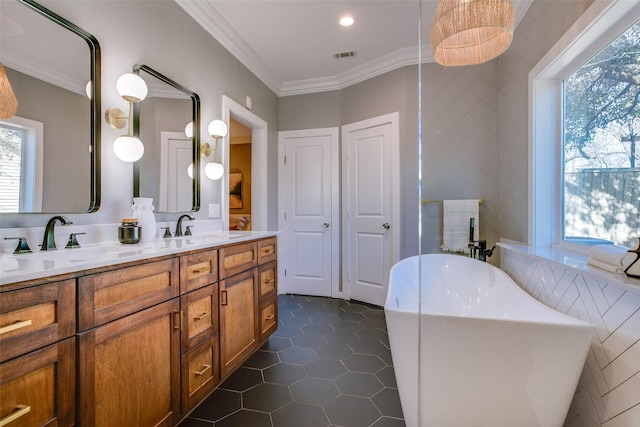 bathroom featuring a wealth of natural light, tile patterned floors, a bath, and vanity