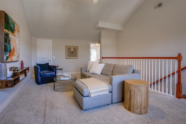 carpeted living room with lofted ceiling