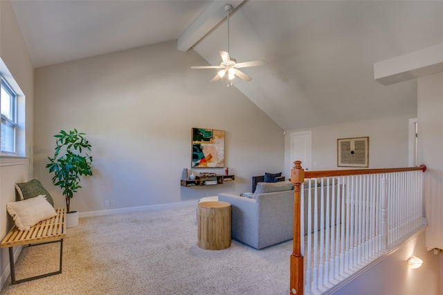 carpeted living room with ceiling fan and lofted ceiling with beams