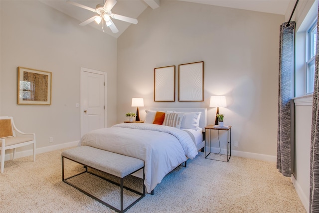 carpeted bedroom with ceiling fan, high vaulted ceiling, and beam ceiling