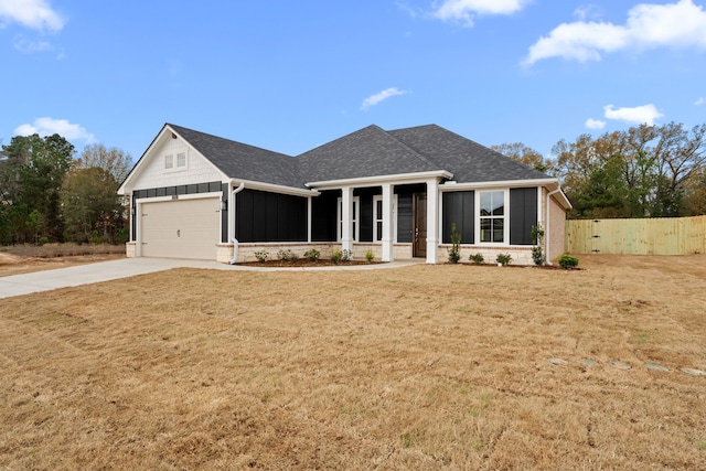 view of front of house featuring a front yard and a garage